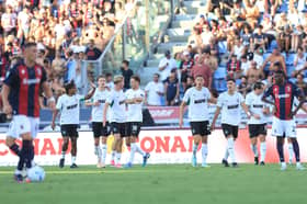Josh Doig is congratulated by his Sassuolo teammates after scoring the opener against Bologna at Stadio Renato Dall'Ara. (Photo by Gabriele Maltinti/Getty Images)