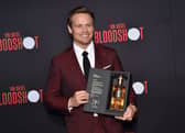 Scottish actor Sam Heughan poses with his newly launched whiskey brand "The Sassenach" as he arrives for the premiere of Sony's "Bloodshot" at the Regency Village theatre on March 10, 2020 in Westwood, California. (Photo by Chris DELMAS / AFP) (Photo by CHRIS DELMAS/AFP via Getty Images)