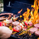 Detail Of Beef Burgers and sausages Cooking On A Barbecue