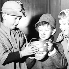 Edinburgh guisers warm their hands over their tumshie lantern in 1956. Picture: TSPL