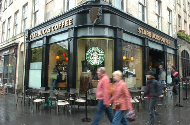 News 09/08/08 Starbucks on the Royal Mile in Edinburgh. Musical tour guide Graeme Pearson has complained about another tour setting up near his pitch after he battled similar complaints from other tours on the Royal Mile.
coffee shops
Edinburgh streets