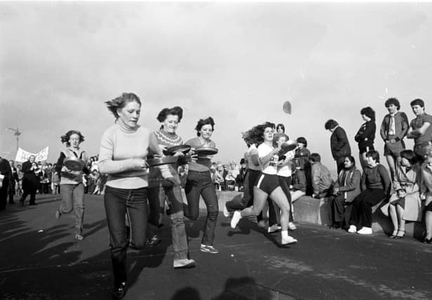 Women taking part in the traditional Shrove Tuesday pancake race along Portobello promenade in February 1982.