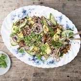 Soba noodle salad tossed with sesame spicy fried mushrooms with quickly pickled cucumbers, spring onions and coriander