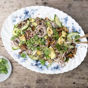 Soba noodle salad tossed with sesame spicy fried mushrooms with quickly pickled cucumbers, spring onions and coriander