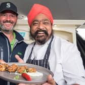 Celebrity Chef Tony Singh cooks up a seafood pakora with the help of fellow scot Iain Coke from the Clipper Yacht Visit Seattle  as the week long Foyle Maritime Festival began this weekend. The event culminates next Sunday (22nd) with the departure of the Clipper Round the World Yacht Race on their final race to Liverpool. Picture Martin McKeown. 14.07.18