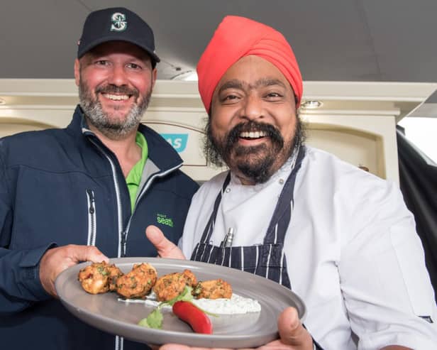 Celebrity Chef Tony Singh cooks up a seafood pakora with the help of fellow scot Iain Coke from the Clipper Yacht Visit Seattle  as the week long Foyle Maritime Festival began this weekend. The event culminates next Sunday (22nd) with the departure of the Clipper Round the World Yacht Race on their final race to Liverpool. Picture Martin McKeown. 14.07.18
