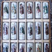 A set of cans featuring Scottish pipers.