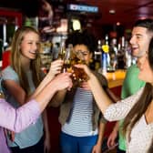 Friends toasting with beer at the bar