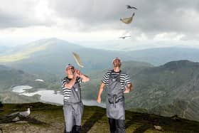 (L) John Henderson-Smith and Darren Gray near the top of Mount Snowdon in Snowdonia National Park in Wales.  Pizza making has reached new heights after two restaurant managers flared dough at the top of Mount Snowdon. See story SWBRpizza. Darren Gray and John Henderson-Smith have taken part in an incredible 10 peak challenge for charity  by doing the five peak challenge TWICE. Upon reaching the summit of Wales' highest mountain, the PizzaExpress managers flared dough to celebrate the chains £2 million fundraising efforts for MacMillan Cancer Support. The daring duos dough throw, believed to be the highest ever performed, was captured on camera in a series of dramatic images amid stunning backdrops.