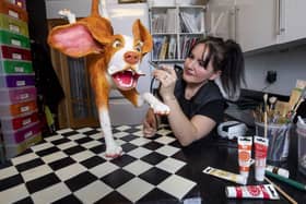 Cake maker Anna Dillon who started making cakes around five years ago with Poppy the dog ckae. Talented baker Anna Dillion, 51, has made an incredible almost life size sculpture of her pet beagle Poppy - out of CAKE! See SWNS story SWSCcake. A talented baker made a nearly-lifesize sculpture of her pet beagle - out of CAKE. Anna Dillon, 51, has turned her hand to celebrity caricatures including actor Sylvester Stallone, and Queen frontman Freddie Mercury, and makes the portraits out of Victoria sponge or Madeira cake. The mum-of-one, who has been making themed cakes for nearly six years, competes in baking shows around the UK as a hobby. She was inspired to make a cake model of her puppy, Poppy, aged eight months, showing the beagle with her ears flying as she leapt through the air.