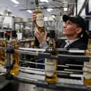 Ailleen McKerron production planners views a Glen Grant Whisky bottle on the bottling line at the new Glen Grant bottling plant at the Glen Grant Distillery