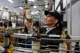 Ailleen McKerron production planners views a Glen Grant Whisky bottle on the bottling line at the new Glen Grant bottling plant at the Glen Grant Distillery