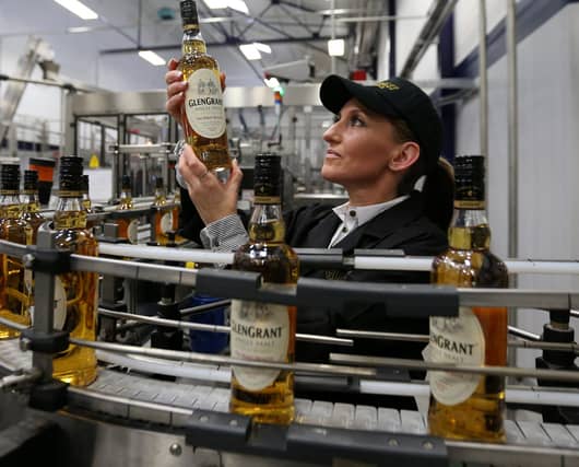 Ailleen McKerron production planners views a Glen Grant Whisky bottle on the bottling line at the new Glen Grant bottling plant at the Glen Grant Distillery