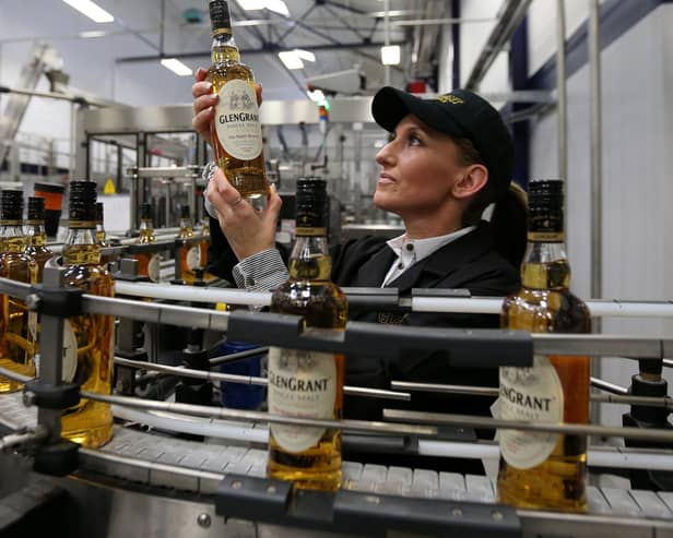 Ailleen McKerron production planners views a Glen Grant Whisky bottle on the bottling line at the new Glen Grant bottling plant at the Glen Grant Distillery