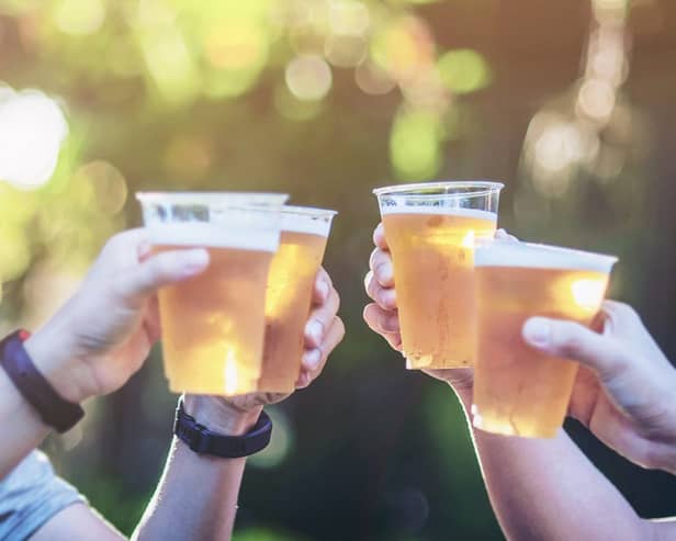 Celebration,Beer,Cheers,Concept,-,Close,Up,Hands,Holding,Up