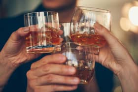 Three,People,Makes,A,Toast,With,Whiskey