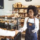 Customer making a credit card payment in a bakery.