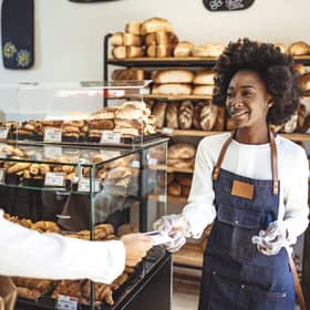 Customer making a credit card payment in a bakery.
