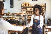 Customer making a credit card payment in a bakery.