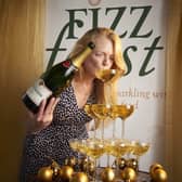 Diana Thompson launching Fizz Feast 2022 sipping from Champagne tower. Photo by Shannon Tofts (1)