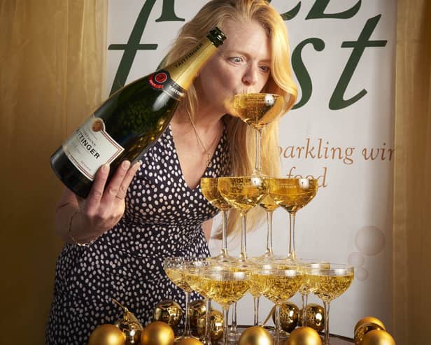 Diana Thompson launching Fizz Feast 2022 sipping from Champagne tower. Photo by Shannon Tofts (1)