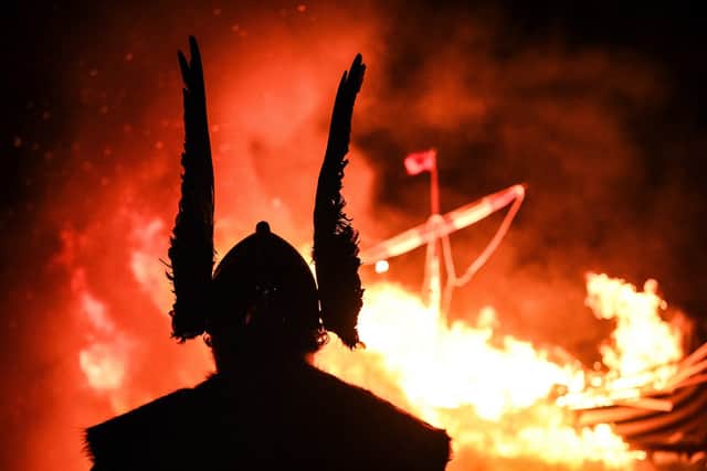 A member of the Junior Up Helly Aa reacts as he looks at a ship burning during the parade through the streets of in Lerwick, Shetland Islands on January 30, 2024 during the Up Helly Aa festival later in the day. Up Helly Aa celebrates the influence of the Scandinavian Vikings in the Shetland Islands and culminates with up to 1,000 'guizers' (men in costume) throwing flaming torches into their Viking longboat and setting it alight later in the evening. (Photo by ANDY BUCHANAN / AFP) (Photo by ANDY BUCHANAN/AFP via Getty Images)
