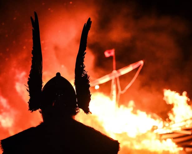 A member of the Junior Up Helly Aa reacts as he looks at a ship burning during the parade through the streets of in Lerwick, Shetland Islands on January 30, 2024 during the Up Helly Aa festival later in the day. Up Helly Aa celebrates the influence of the Scandinavian Vikings in the Shetland Islands and culminates with up to 1,000 'guizers' (men in costume) throwing flaming torches into their Viking longboat and setting it alight later in the evening. (Photo by ANDY BUCHANAN / AFP) (Photo by ANDY BUCHANAN/AFP via Getty Images)