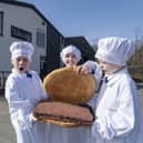 Ayrshire butcher We hae meat has created the ‘world’s largest’ square sausage slice to mark the inaugural National Square Sausage Day, taking place on 25 March. Pictured with the enormous square sausage, in its roll produced by The Breadwinner Bakery, are Jamie (8), Daisy (8) and Leo (9) from Dailly Primary School’s P4 & 5 class.