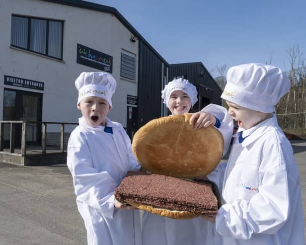 Ayrshire butcher We hae meat has created the ‘world’s largest’ square sausage slice to mark the inaugural National Square Sausage Day, taking place on 25 March. Pictured with the enormous square sausage, in its roll produced by The Breadwinner Bakery, are Jamie (8), Daisy (8) and Leo (9) from Dailly Primary School’s P4 & 5 class.