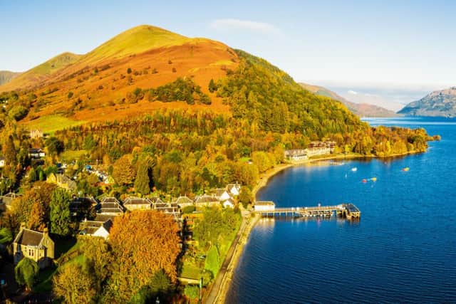 A view of Loch Lomond on a clear, sunny autumn day, with the village of Luss at the left hand side, and Ben Lomond on the horizon.