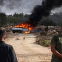 A car burns after clashes between Israeli settlers and Palestinians outside the occupied West Bank village of Turmos Ayya near Ramallah in October last year (Picture: Hazem Bader)