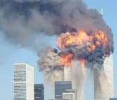 The Twin Towers of the World Trade Center in New York are engulfed in flames after being hit by two planes on September 11, 2001 (Picture: Spencer Platt)