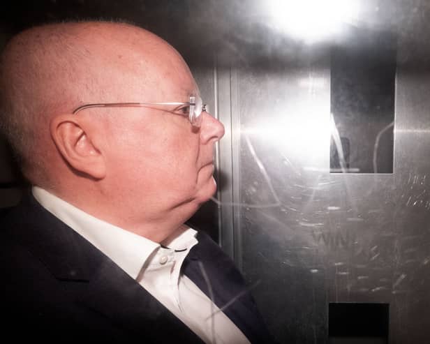 Side view of Peter Murrell in the back of a prison van