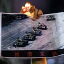 A man at a candlelight vigil in Hong Kong in 2020 holds a photograph of the famous 'Tank Man' standing in front of a column of Chinese tanks in Tiananmen Square, Beijing, in June 1989 (Picture: Anthony Wallace)