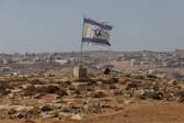 An Israeli flag flies near the settlement of Carmel in the South Hebron Hills of the West Bank (Picture: Tamir Kalifa)