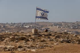 An Israeli flag flies near the settlement of Carmel in the South Hebron Hills of the West Bank (Picture: Tamir Kalifa)