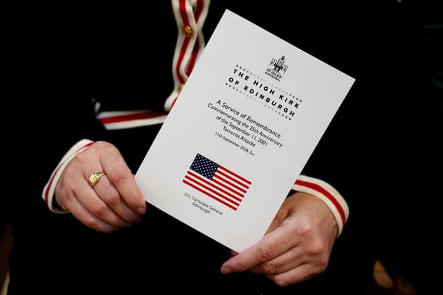 A member of the congregation holds the order of service for a remembrance service, commemorating the 25th anniversary of the 9/11 terrorist attacks, at St Giles' Cathedral in Edinburgh.