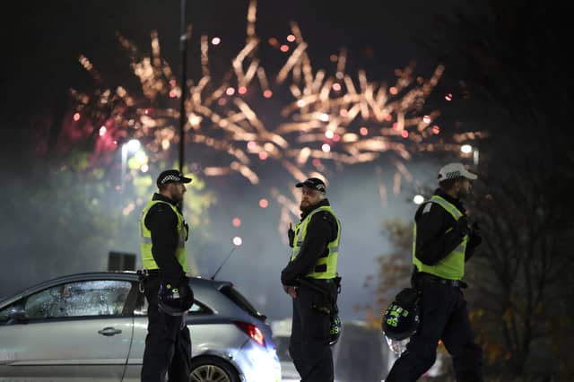 Police officers patrol the streets in Edinburgh as fireworks go off in the distance on November 5 last year, when at least they were expected (Picture: Jeff J Mitchell)