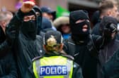 Wearing balaclavas to hide their identities, anti-immigration protesters stage a counter-demonstration during an anti-racism rally in Glasgow in June (Picture: Jeff J Mitchell)