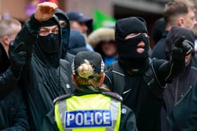 Wearing balaclavas to hide their identities, anti-immigration protesters stage a counter-demonstration during an anti-racism rally in Glasgow in June (Picture: Jeff J Mitchell)
