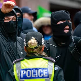 Wearing balaclavas to hide their identities, anti-immigration protesters stage a counter-demonstration during an anti-racism rally in Glasgow in June (Picture: Jeff J Mitchell)