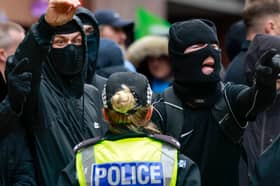 Wearing balaclavas to hide their identities, anti-immigration protesters stage a counter-demonstration during an anti-racism rally in Glasgow in June (Picture: Jeff J Mitchell)
