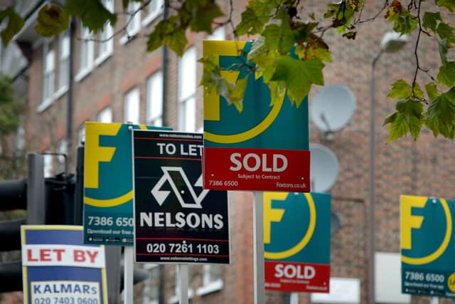 To let, for sale and sold signs outside a property