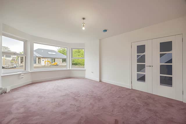 The bright and generously sized living area provides a welcoming central space within the five-bedroom home