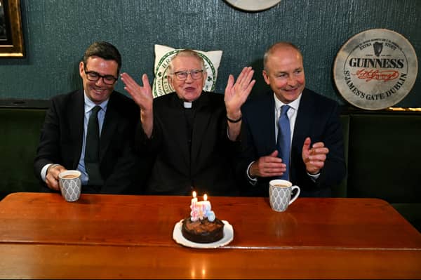 Andy Burnham, left, and Irish Prime Minister Micheal Martin sit either side of Canon Patrick J MacNally as he celebrates his 90th birthday at the Brian Boru Irish Club in Ashton-in-Makerfield (Picture: Oli Scarff/WPA pool)