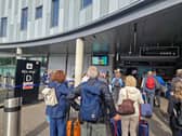 Passengers gather outside Edinburgh Airport amid a number of cancellations and delays to flights. 