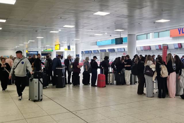 Passengers checking in at Glasgow Airport during the September 21 disruption