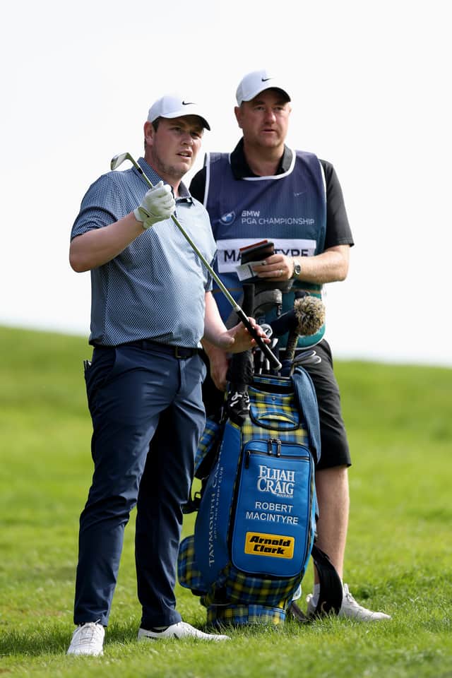 Bob MacIntyre discusses a club selection with caddie Mike Burrow during the final round of the BMW PGA Championship at Wentworth on Sunday