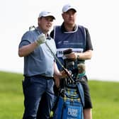 Bob MacIntyre discusses a club selection with caddie Mike Burrow during the final round of the BMW PGA Championship at Wentworth on Sunday