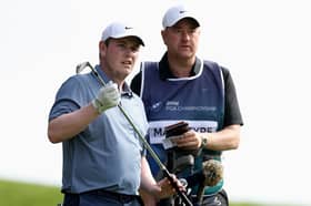 Bob MacIntyre discusses a club selection with caddie Mike Burrow during the final round of the BMW PGA Championship at Wentworth on Sunday
